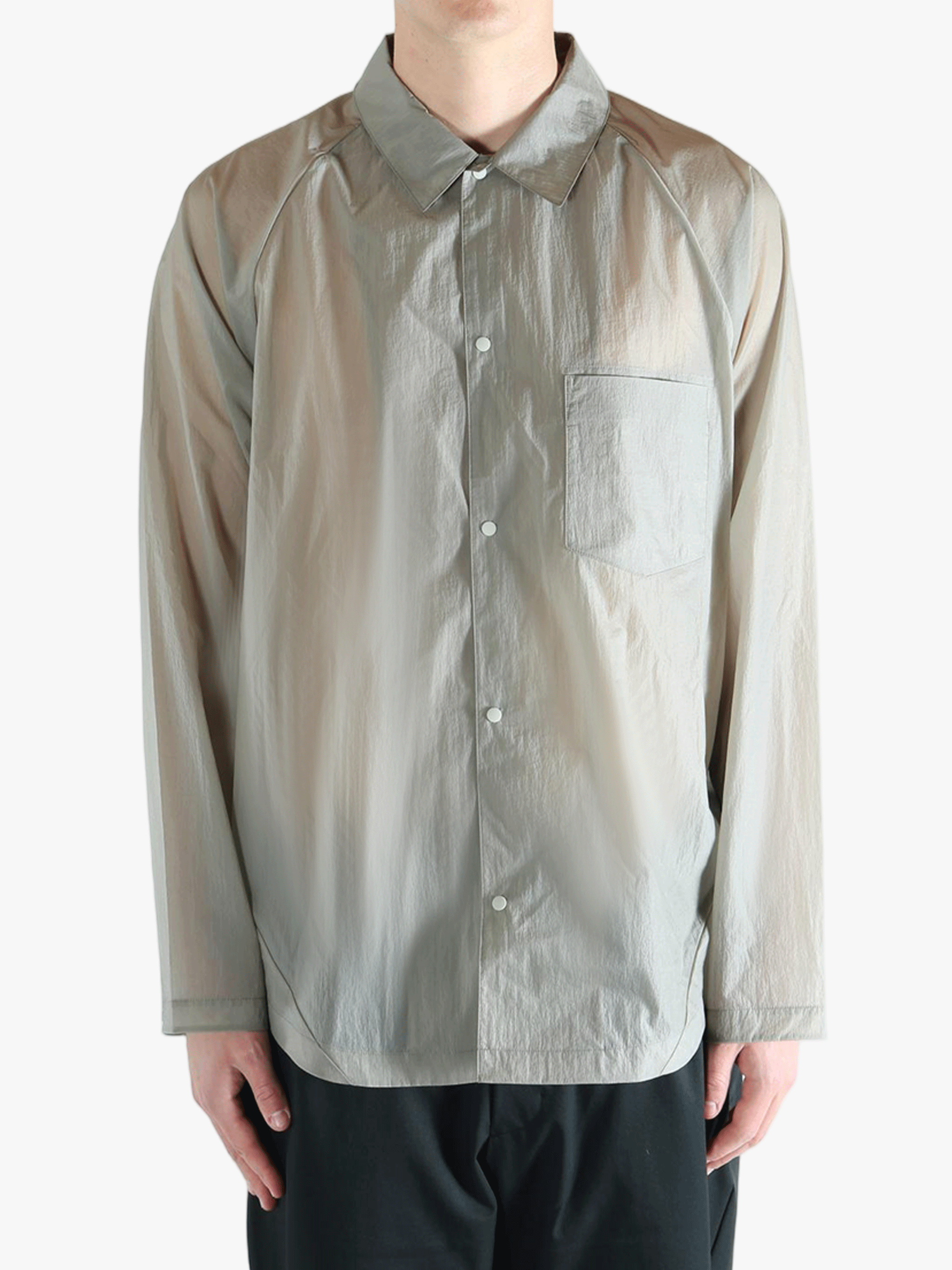 Grey shirt worn by a person, showing the shirt's fit