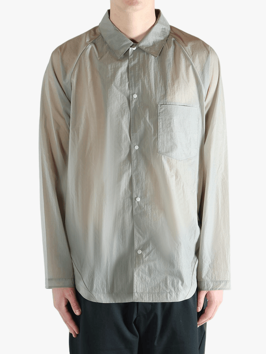 Grey shirt worn by a person, showing the shirt's fit