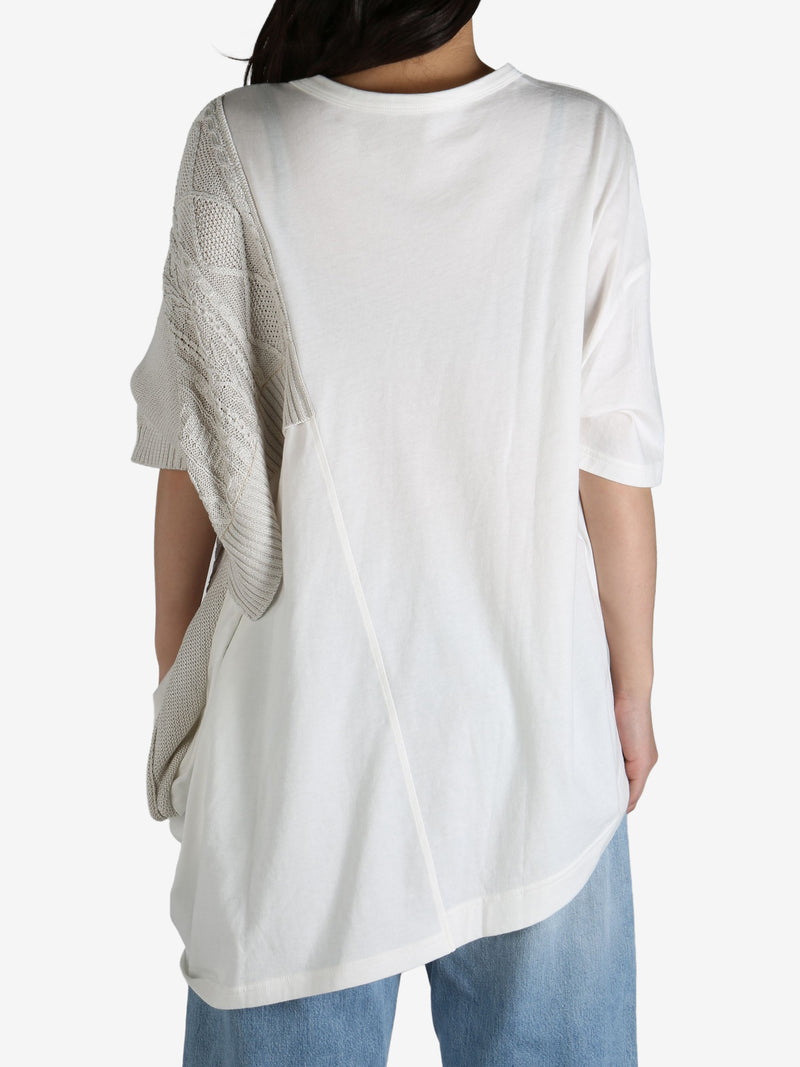 White top worn by a person, showing the top's fit