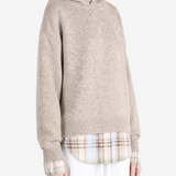 Tan knitwear worn by a person, showing the knitwear fit