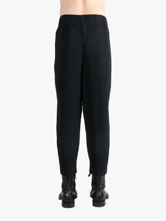 Black pant worn by a person, showing the pants fit