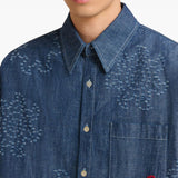 Close up of blue shirts, showing texture of the cotton fabric