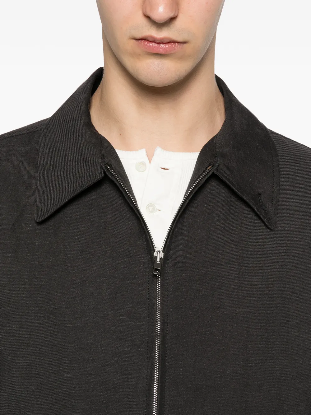 Close up of black jacket, showing texture of the cotton fabric