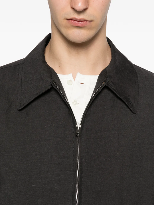Close up of black jacket, showing texture of the cotton fabric