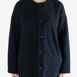 Black jacket worn by a person, showing the jacket fit