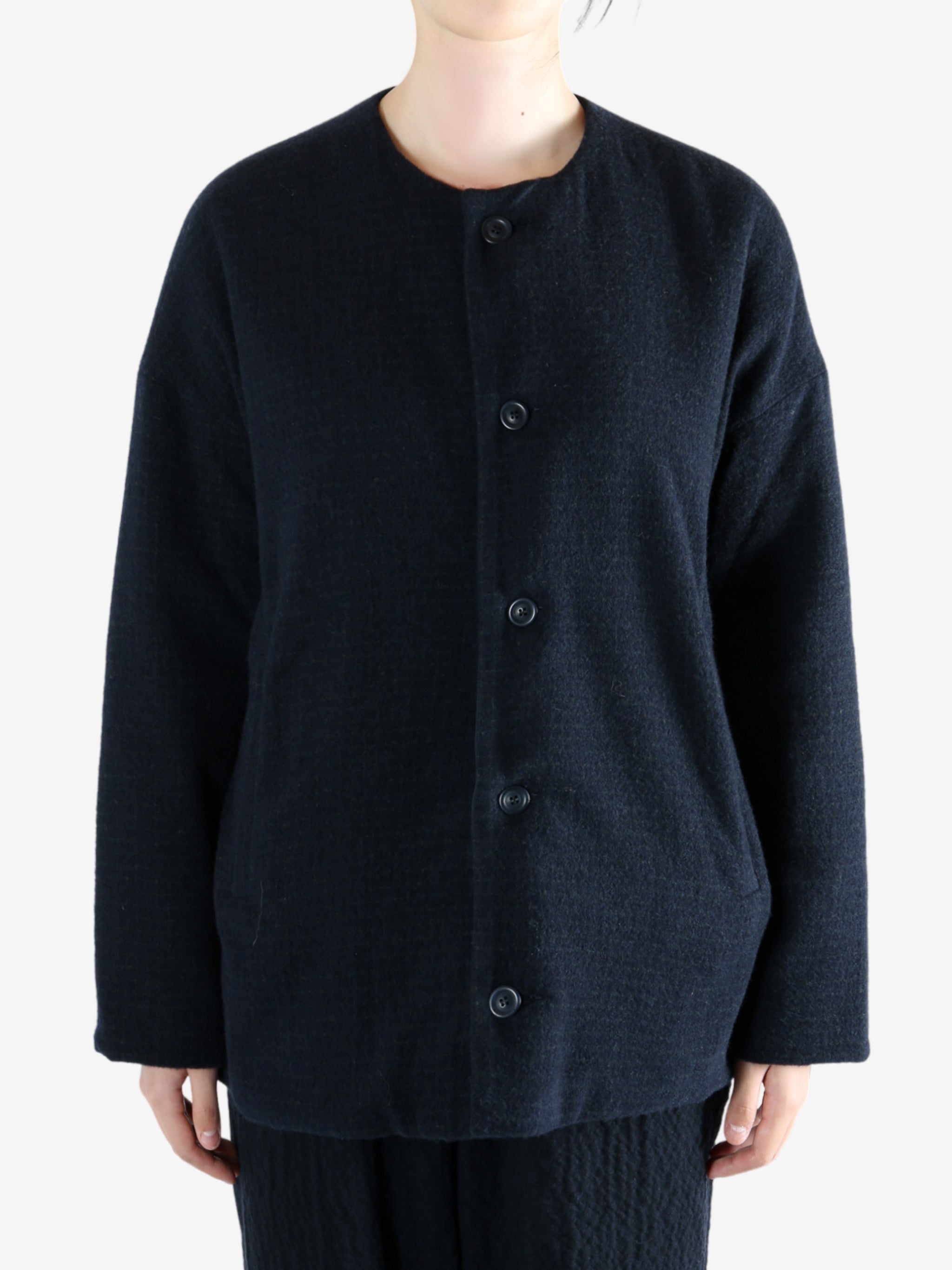 Black jacket worn by a person, showing the jacket fit