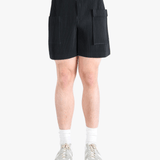 Black pants worn by a person, showing the pants fit