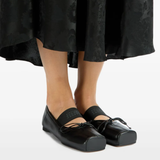 Black shoes worn by a person, showing the shoes fit