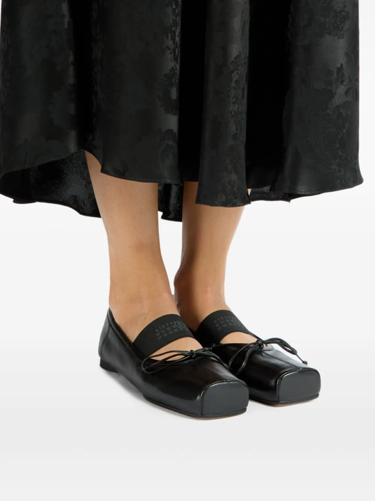 Black shoes worn by a person, showing the shoes fit