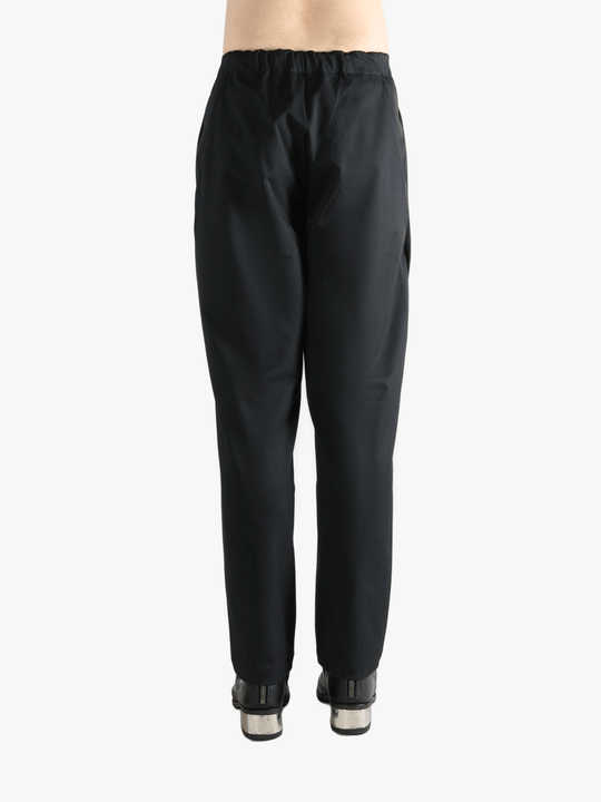 Black pants worn by a person, showing the pants' fit