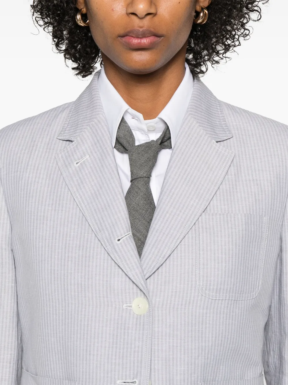 Close up of grey jacket, showing texture of the linen fabric