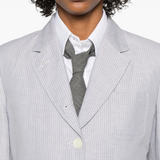 Close up of grey jacket, showing texture of the linen fabric