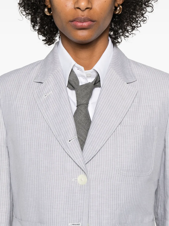 Close up of grey jacket, showing texture of the linen fabric