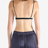 Black bra worn by a person, showing the bra's fit