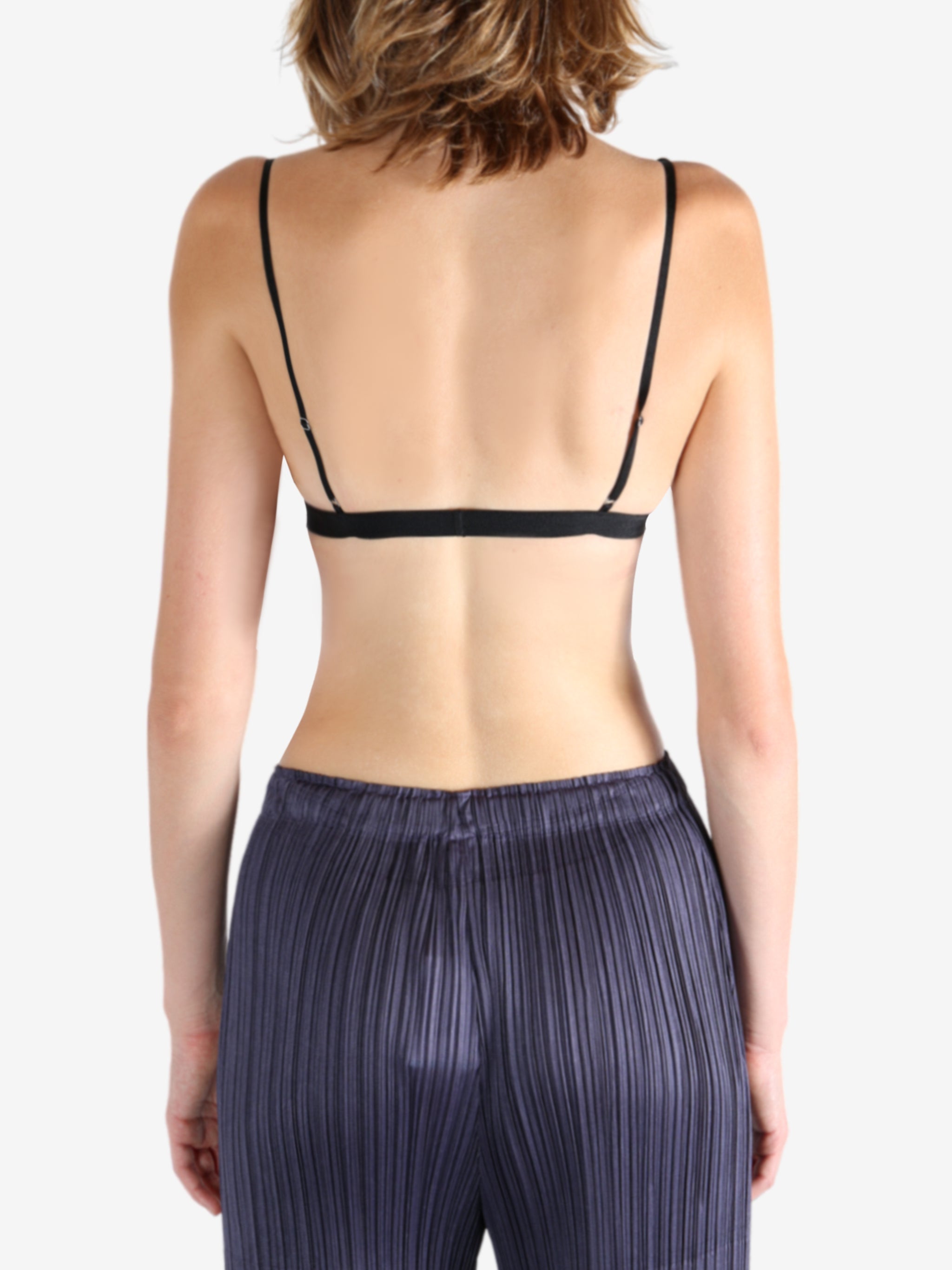 Black bra worn by a person, showing the bra's fit