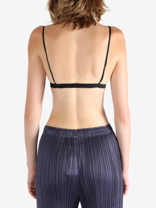 Black bra worn by a person, showing the bra's fit