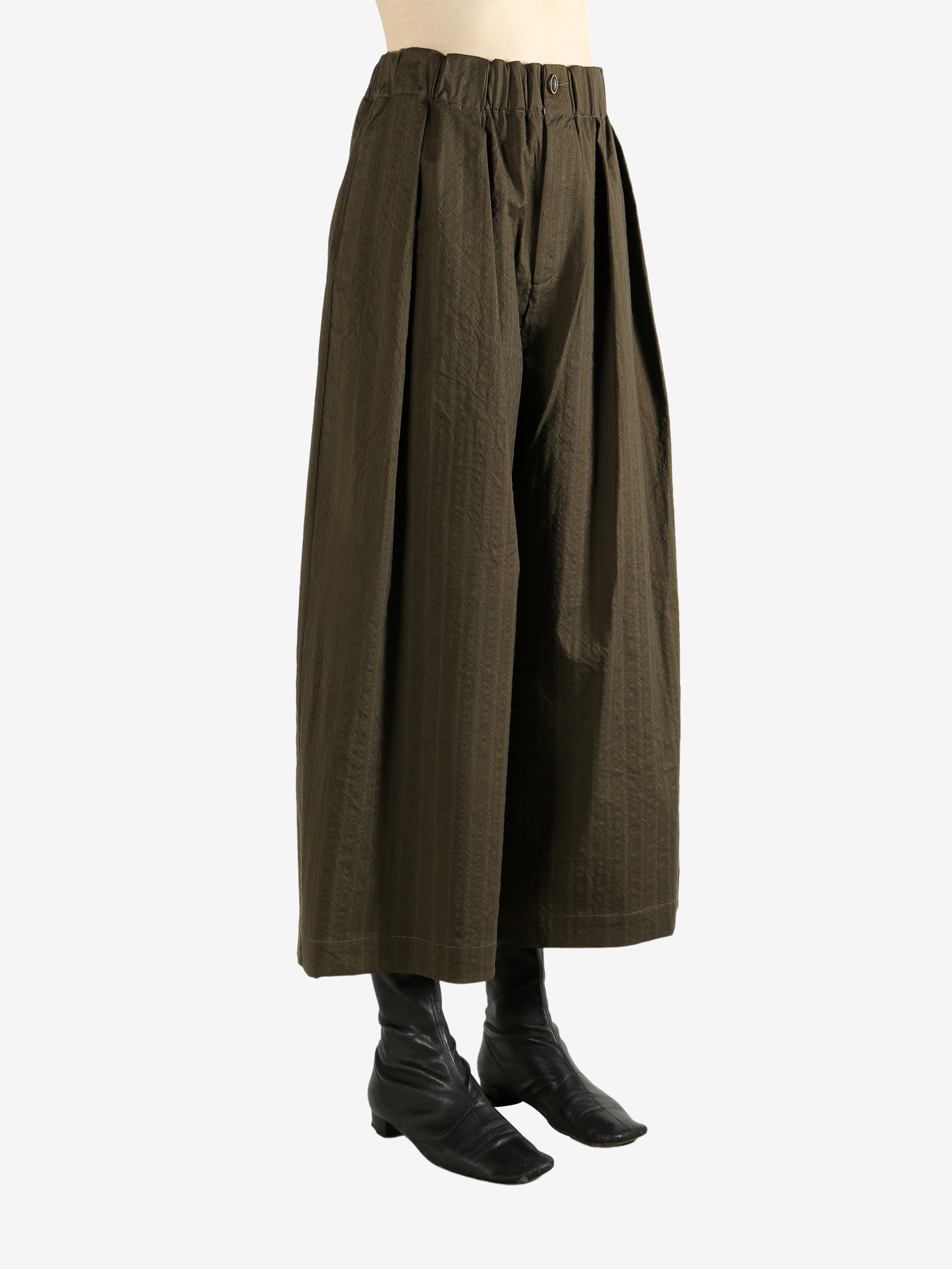 Brown pants  worn by a person, showing the pants's fit