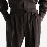 Brown pants worn by a person, showing the pants fit