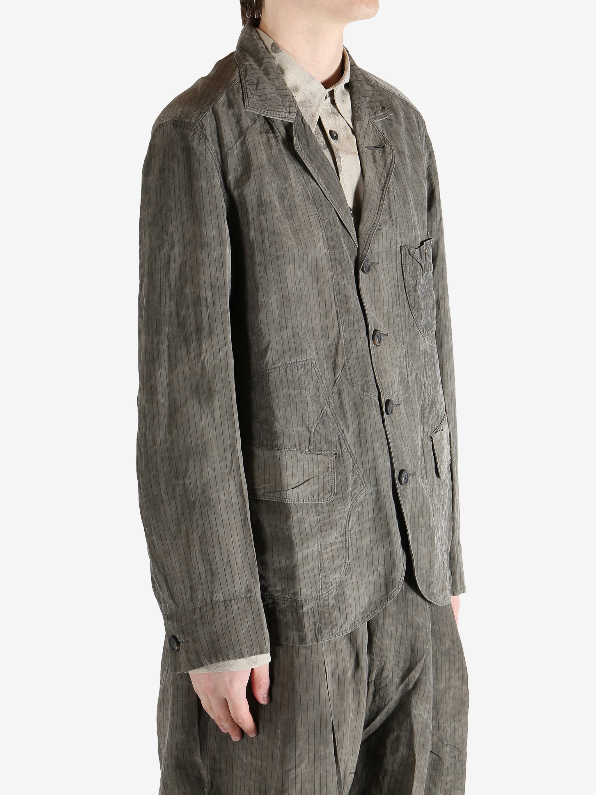 Grey jacket worn by a person, showing the jacket fit