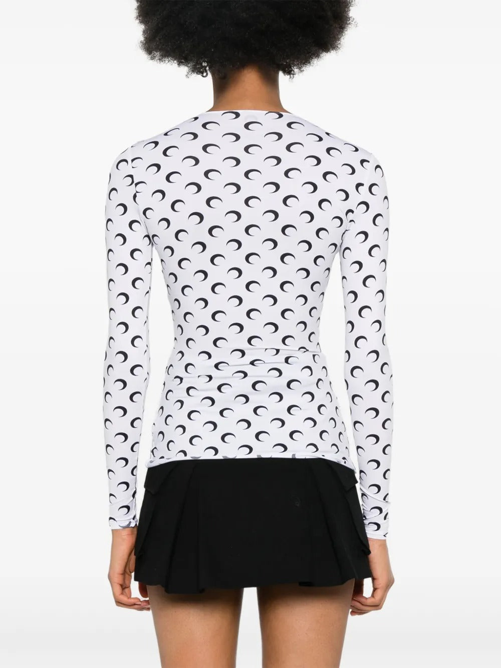 White top worn by a person, showing the top's fit