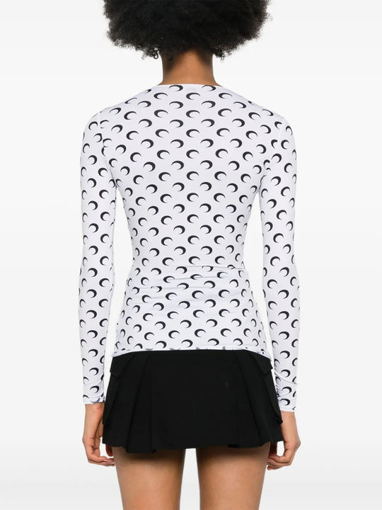 White top worn by a person, showing the top's fit