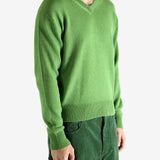 Green knitwear worn by a person, showing the knitwear's fit