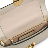 Close up of the white bag, showing texture of the leather fabric