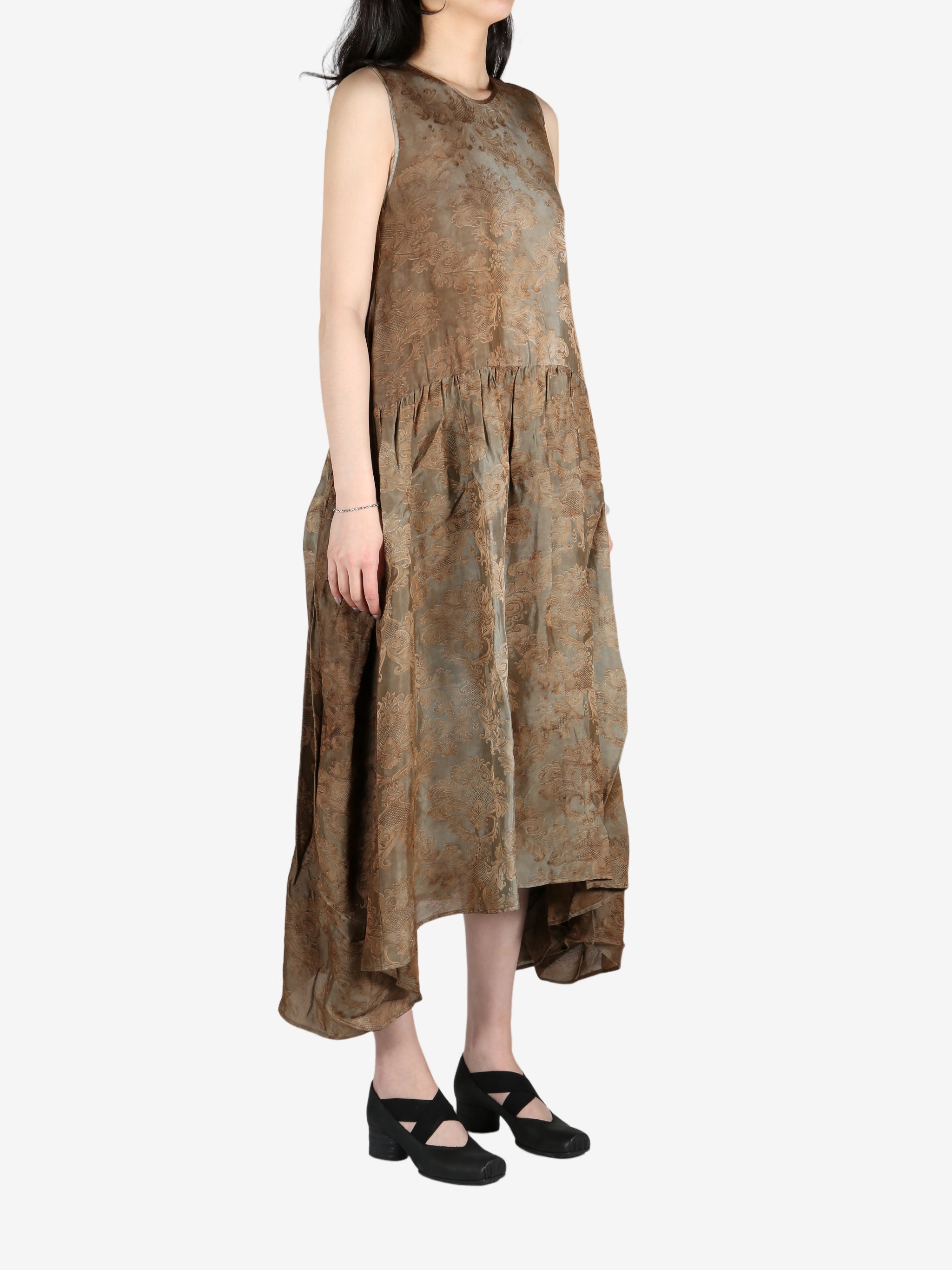 Brown dress worn by a person, showing the dress's fit