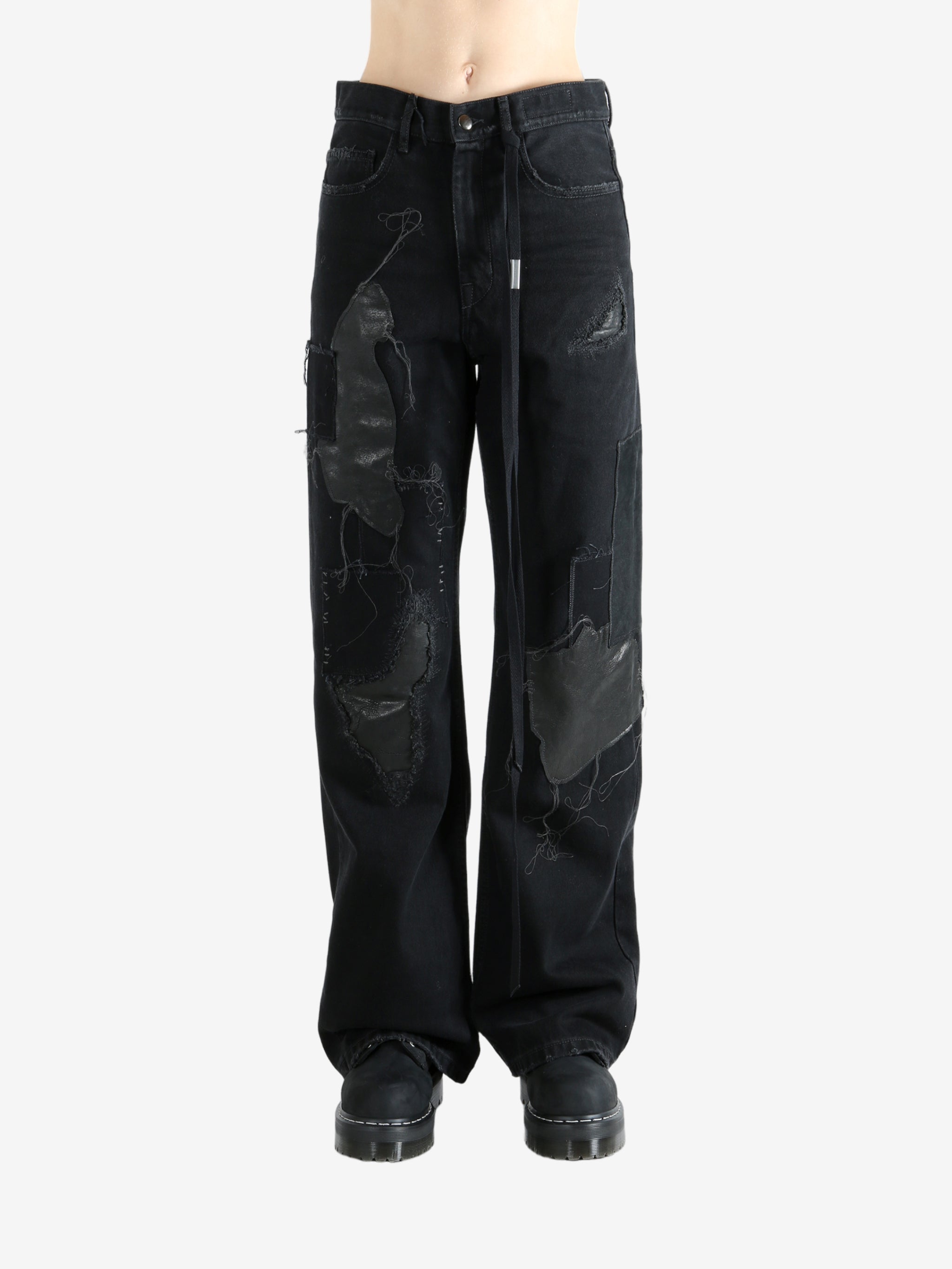 Black pants worn by a person, showing the pants' fit