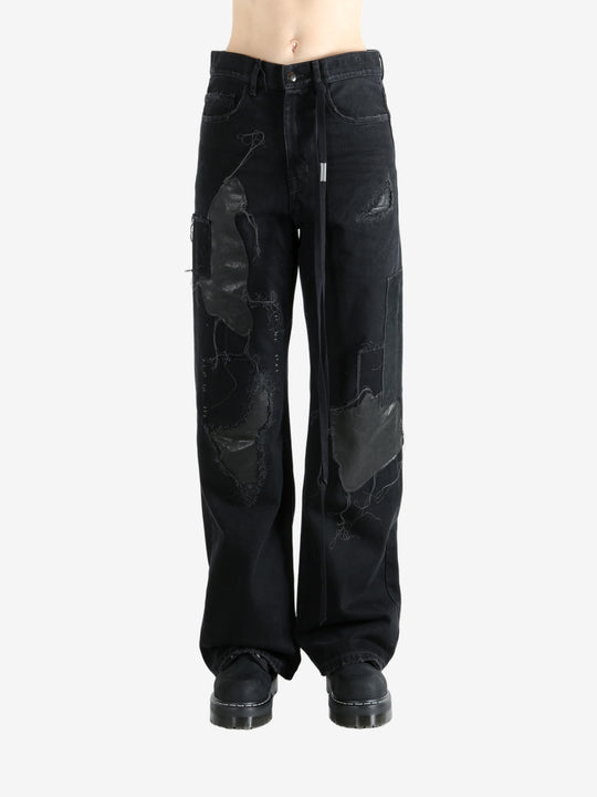 Black pants worn by a person, showing the pants' fit