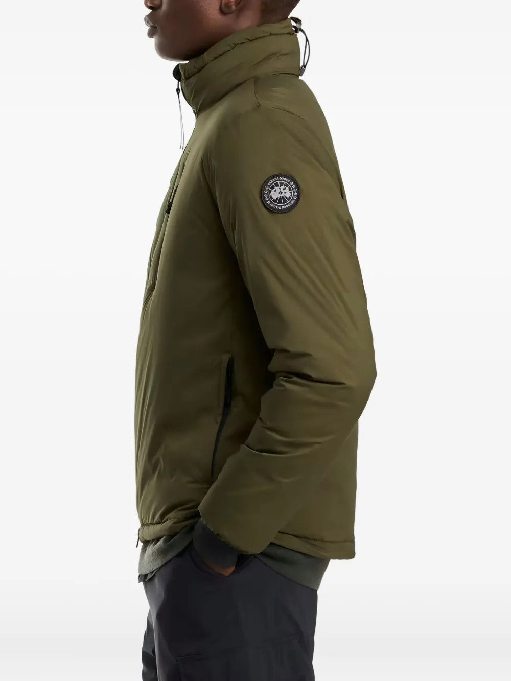 Green jacket worn by a person, showing the jacket fit