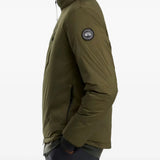 Green jacket worn by a person, showing the jacket fit