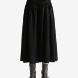 Black skirt worn by a person, showing the skirt fit