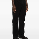 Black pants worn by a person, showing the pants fit