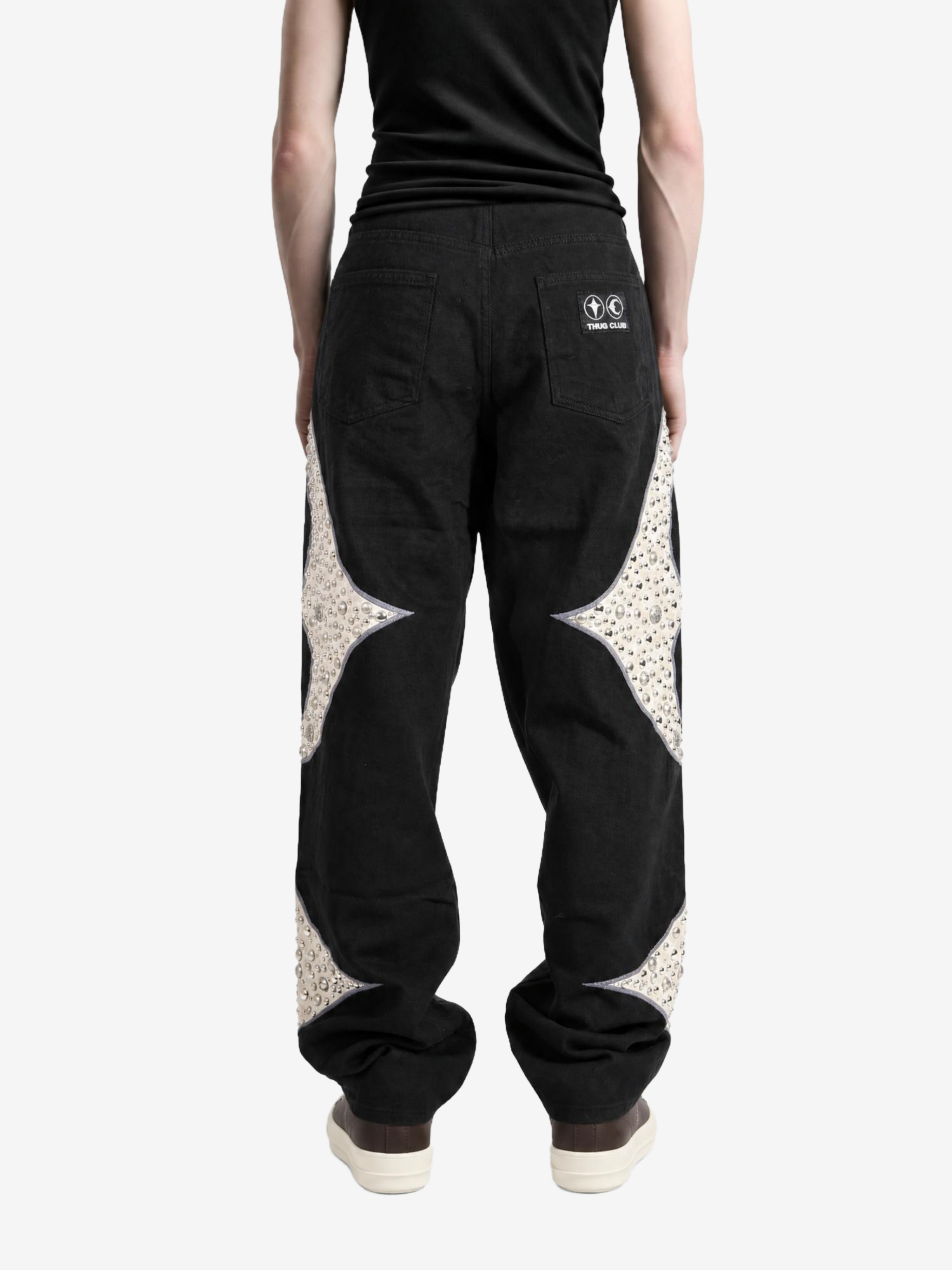 Black pants worn by a person, showing the pants fit