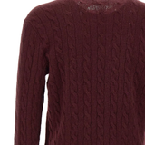 Close up of red knitwear, showing texture of the wool fabric
