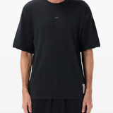 Black t-shirt worn by a person, showing the shirt's fit