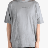 Grey t-shirt worn by a person, showing the t-shirt's fit