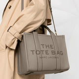 Grey bag carried by a person, showing the bag's size