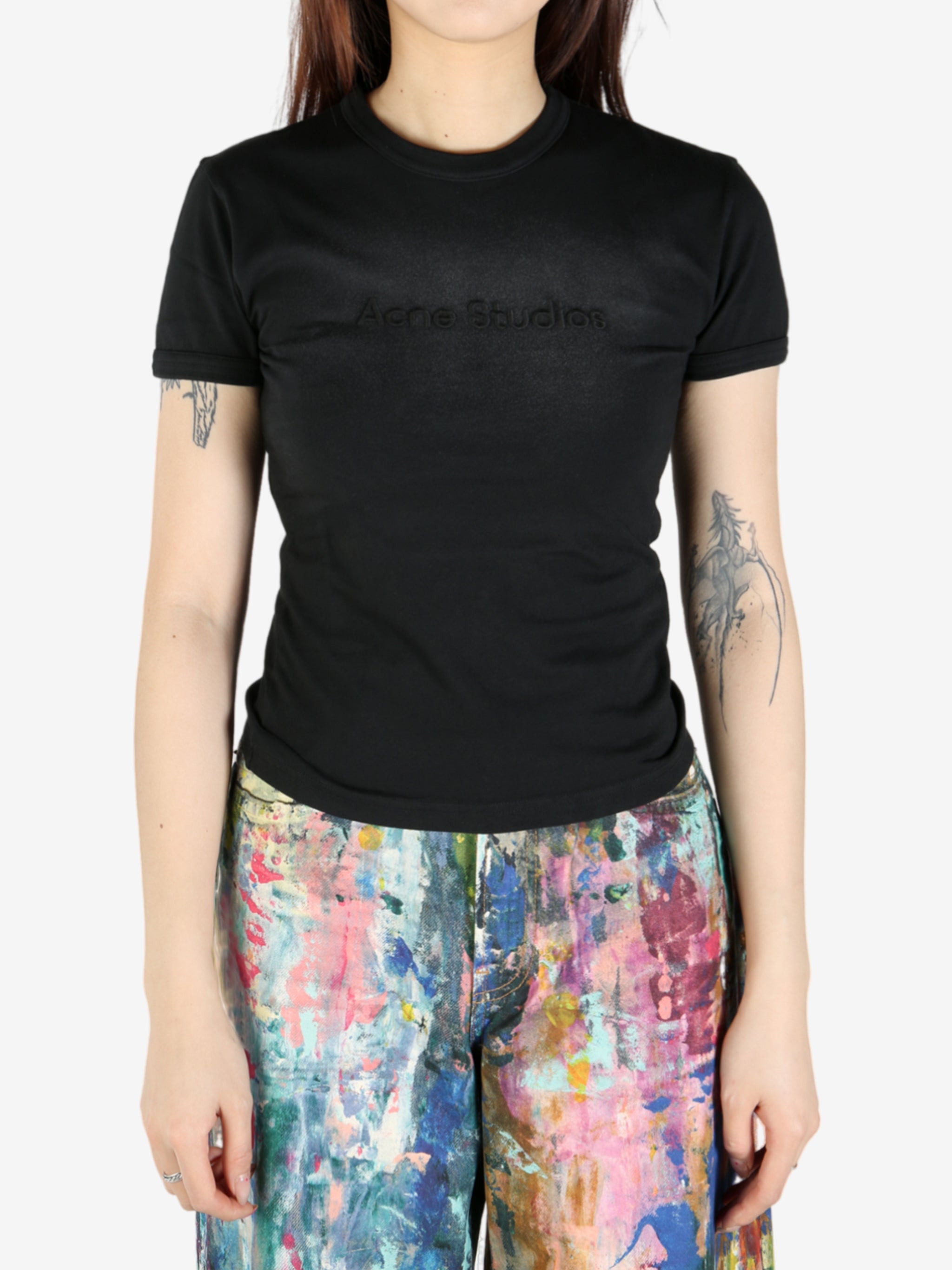 Black T-shirt worn by a person, showing the shirt's fit