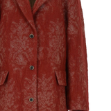 Close up of red jackets, showing texture of the wool fabric