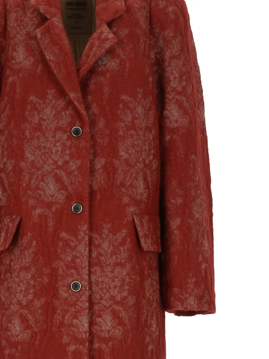 Close up of red jackets, showing texture of the wool fabric