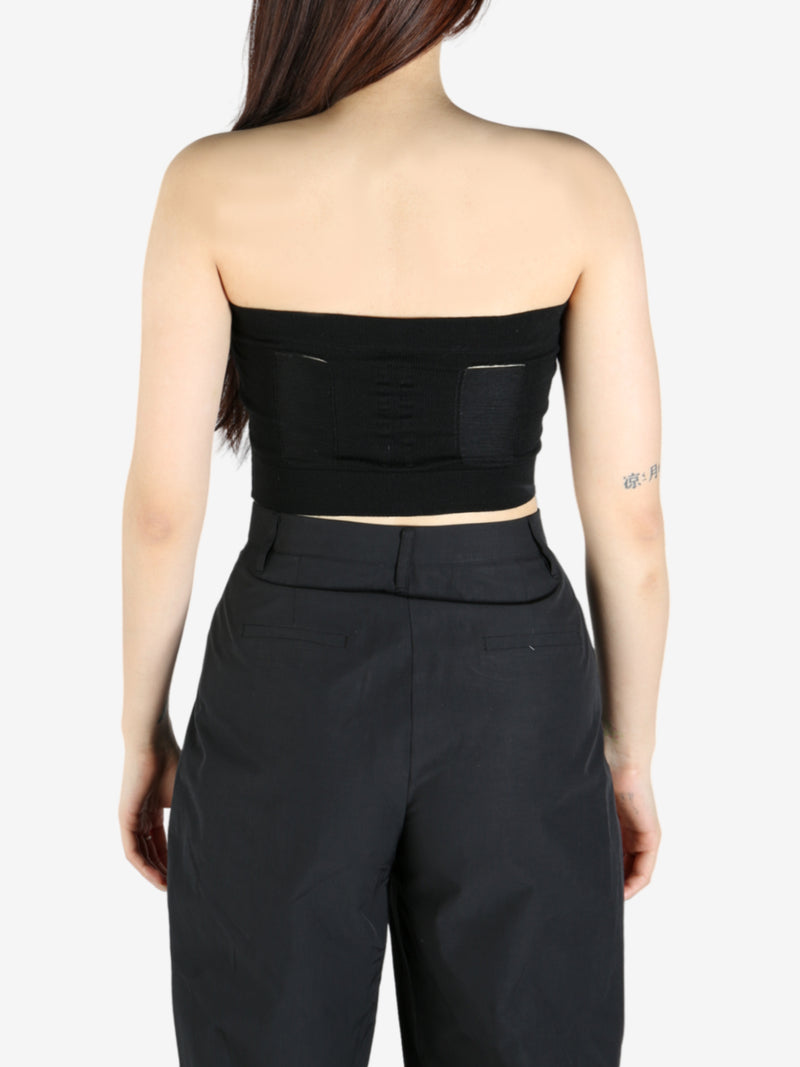 Black top worn by a person, showing the top's fit