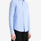 Blue shirt worn by a person, showing the shirt fit