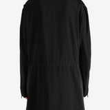 Black coat worn by a person, showing the coat fit