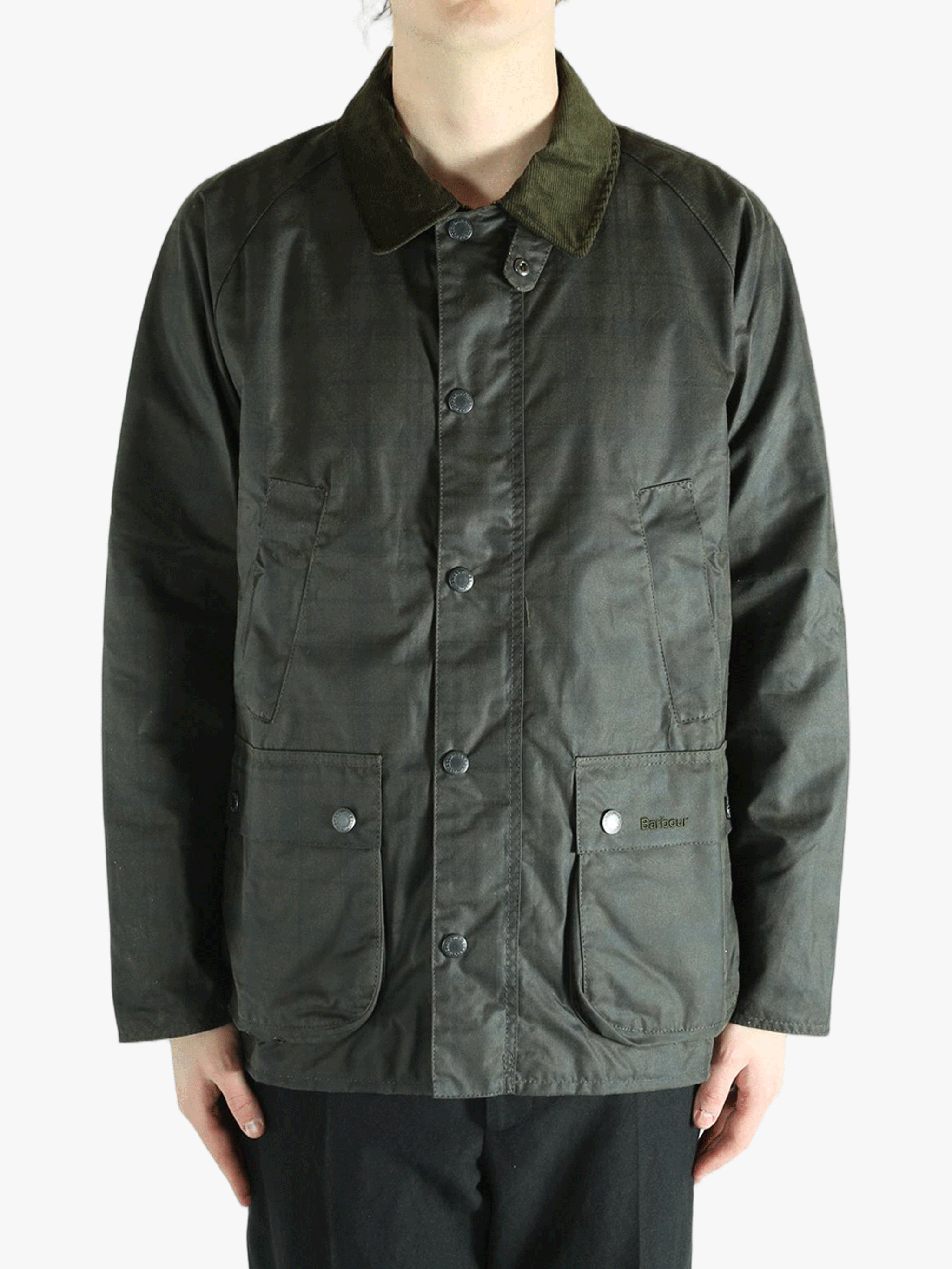 Green jacket worn by a person, showing the jacket's fit