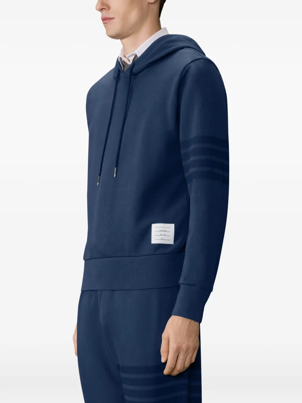 navy hoodie worn by a person, showing the hoodie fit