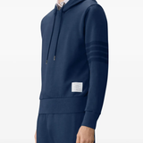 navy hoodie worn by a person, showing the hoodie fit