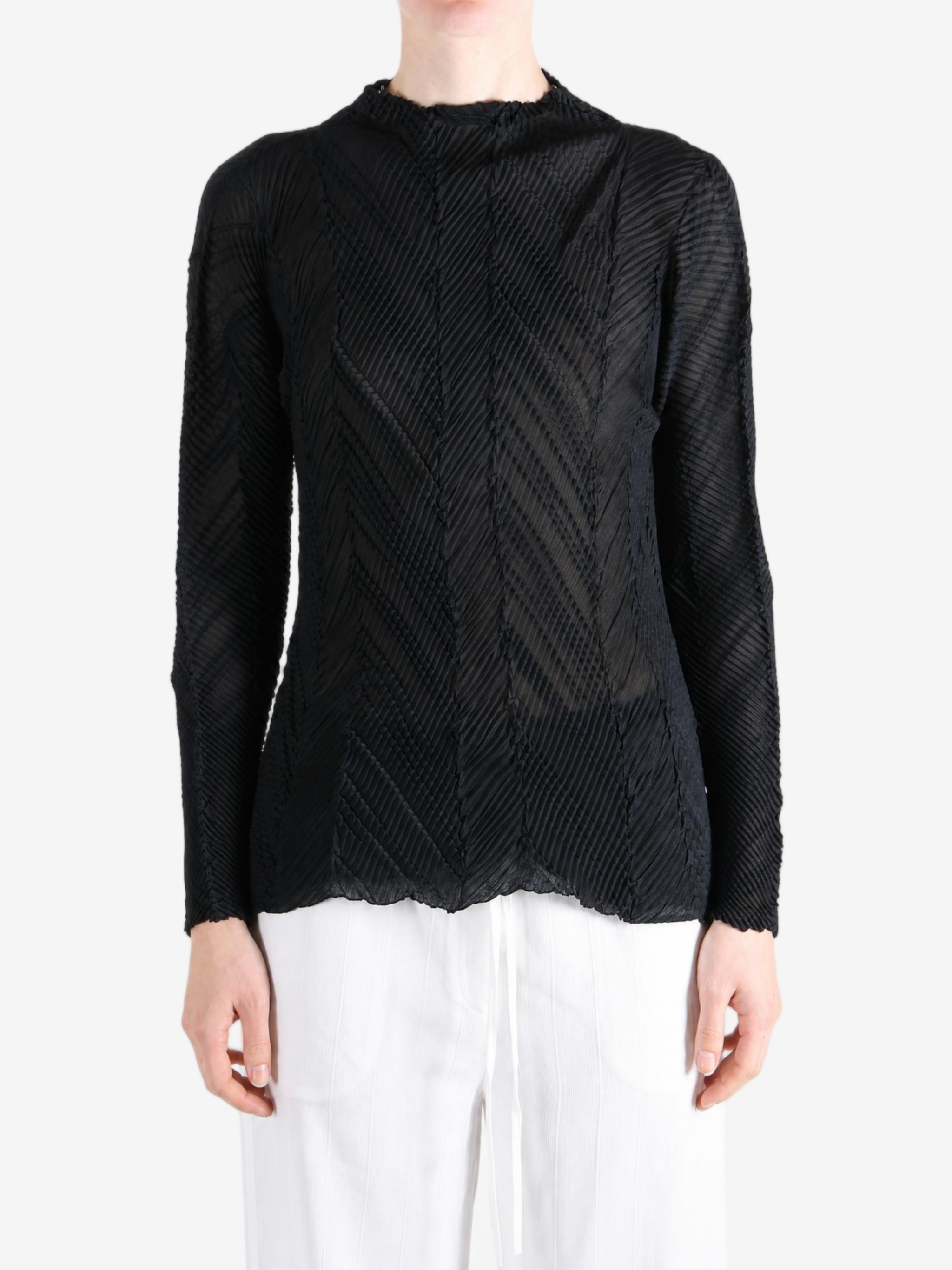 Black shirt worn by a person, showing the shirt fit