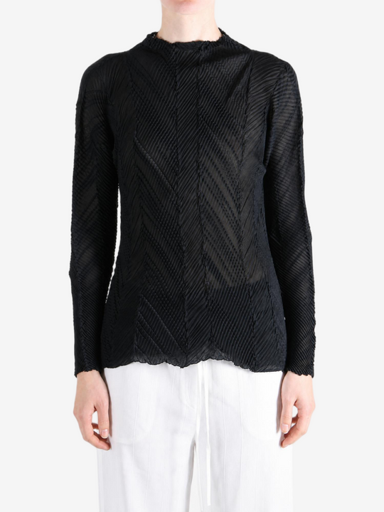 Black shirt worn by a person, showing the shirt fit